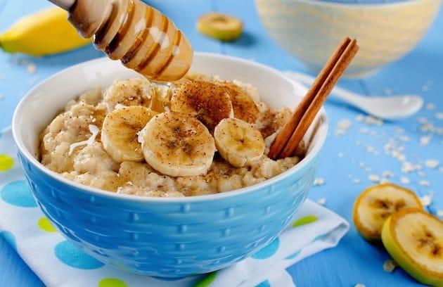 Oatmeal with banana, honey and cinnamon. Breakfast on a blue background